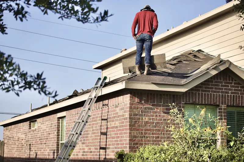 Professional roofer working on a residential roof in Tega Cay
